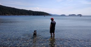 Odin and Jay wade in the Pacific Ocean outside of Vancouver