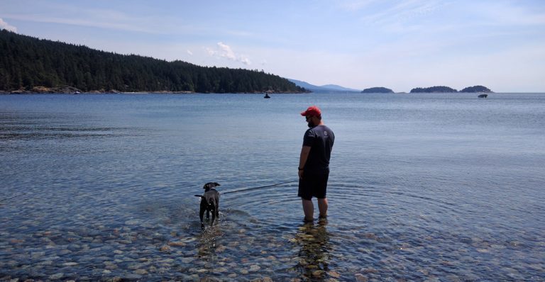 Odin and Jay wade in the Pacific Ocean outside of Vancouver