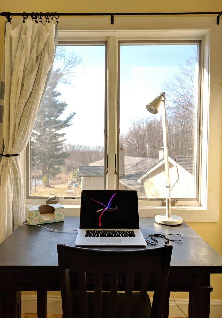 A clean laptop workstation overlooking the family run Retrograss Farm