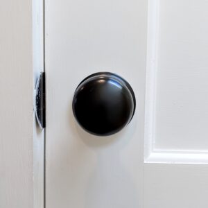 Smooth black door knobs on a clean white door