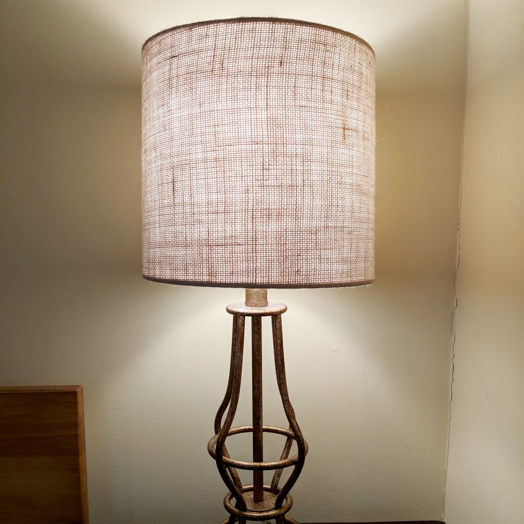 Brass bedside lamp with a burlap cloth lampshade