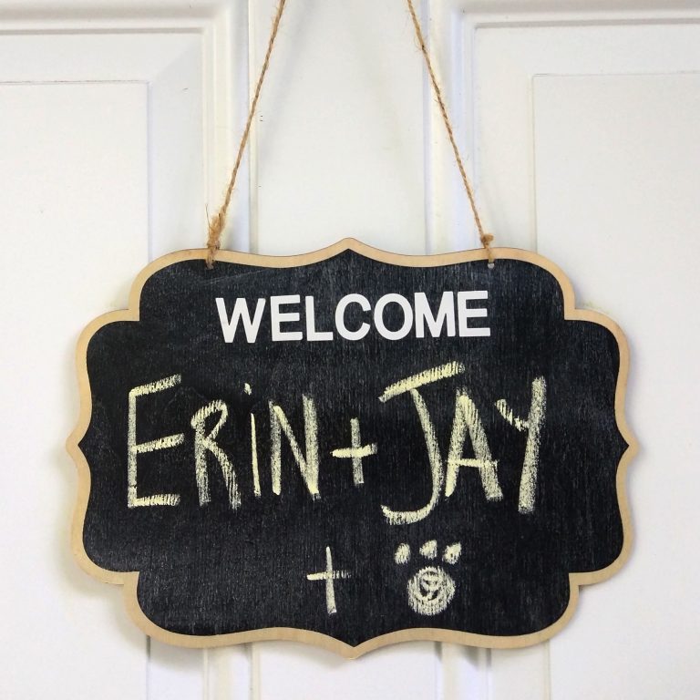 A sign hangs to welcome us to our new Airbnb home: "WELCOME! Erin + Jay + Puppy"