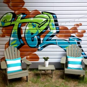 Lawn chairs and graffiti artwork in a private yard