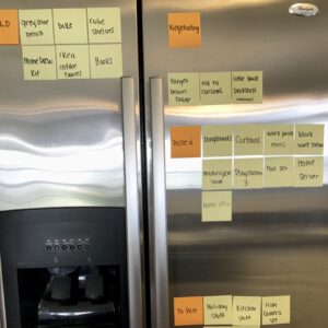 Sticky notes decorate a fridge as we keep track of all the items being sold on Craigslist