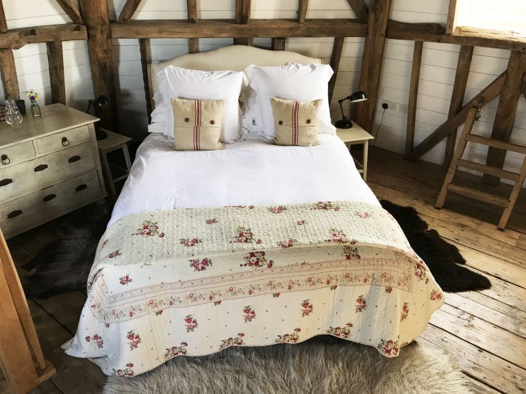 bed with quilt and throwpillows