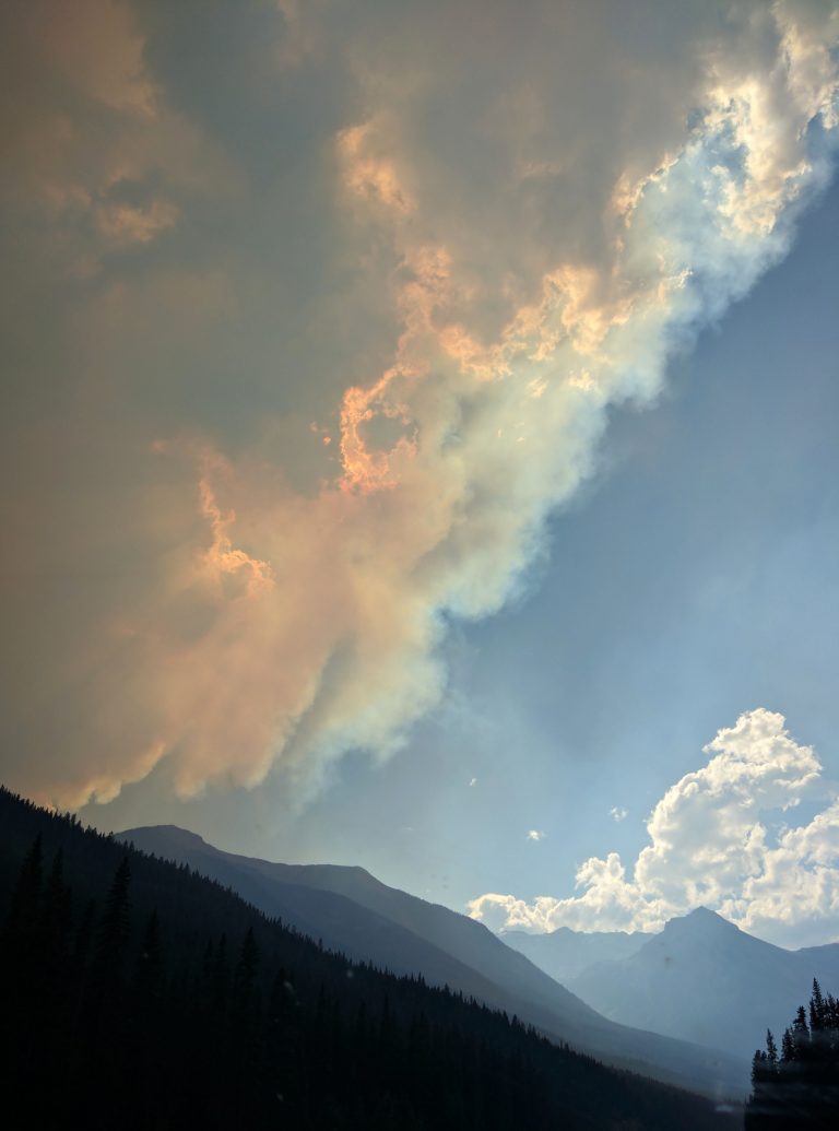 mountains in banff national park smoke from fire