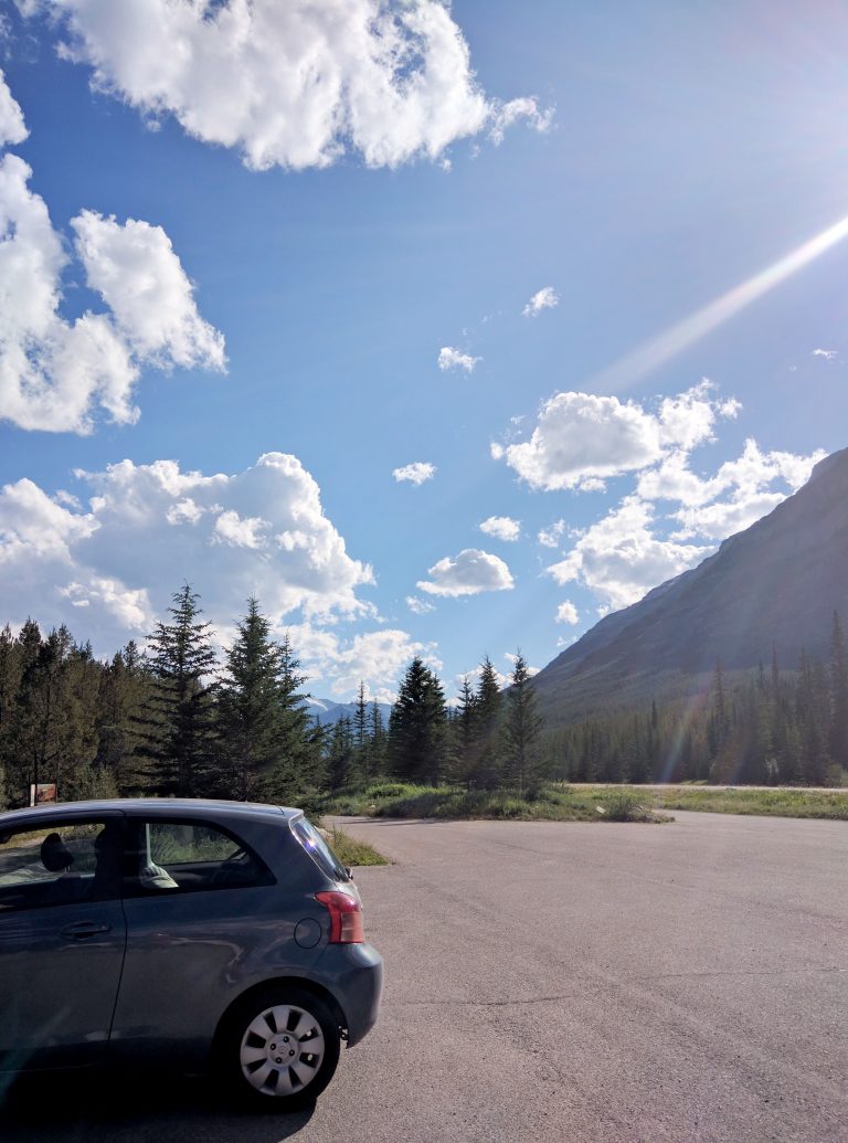 hatchback car in banff national park on a sunny day