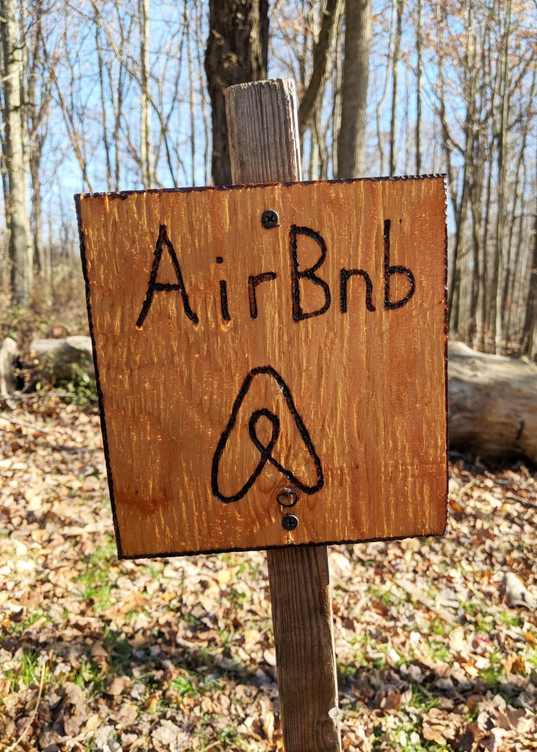 wooden parking sign with Airbnb on it