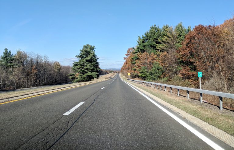 taconic state parkway with no cars and lots of fall leaves