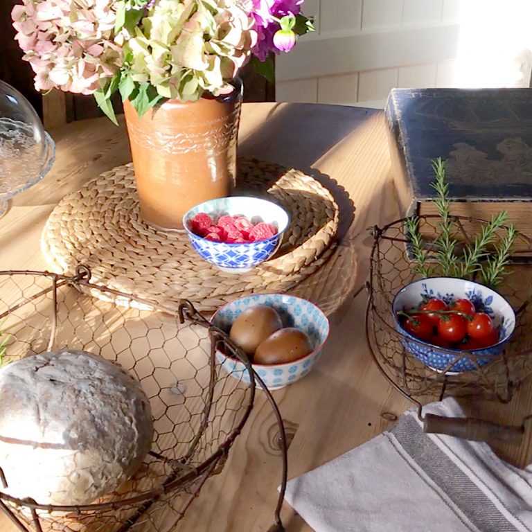 table with flowers, bread, cherry tomatoes