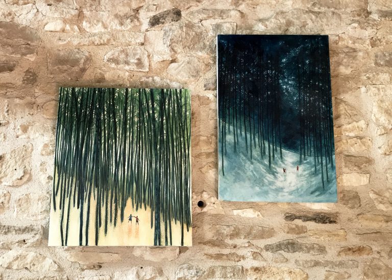 side by side paintings on stone wall