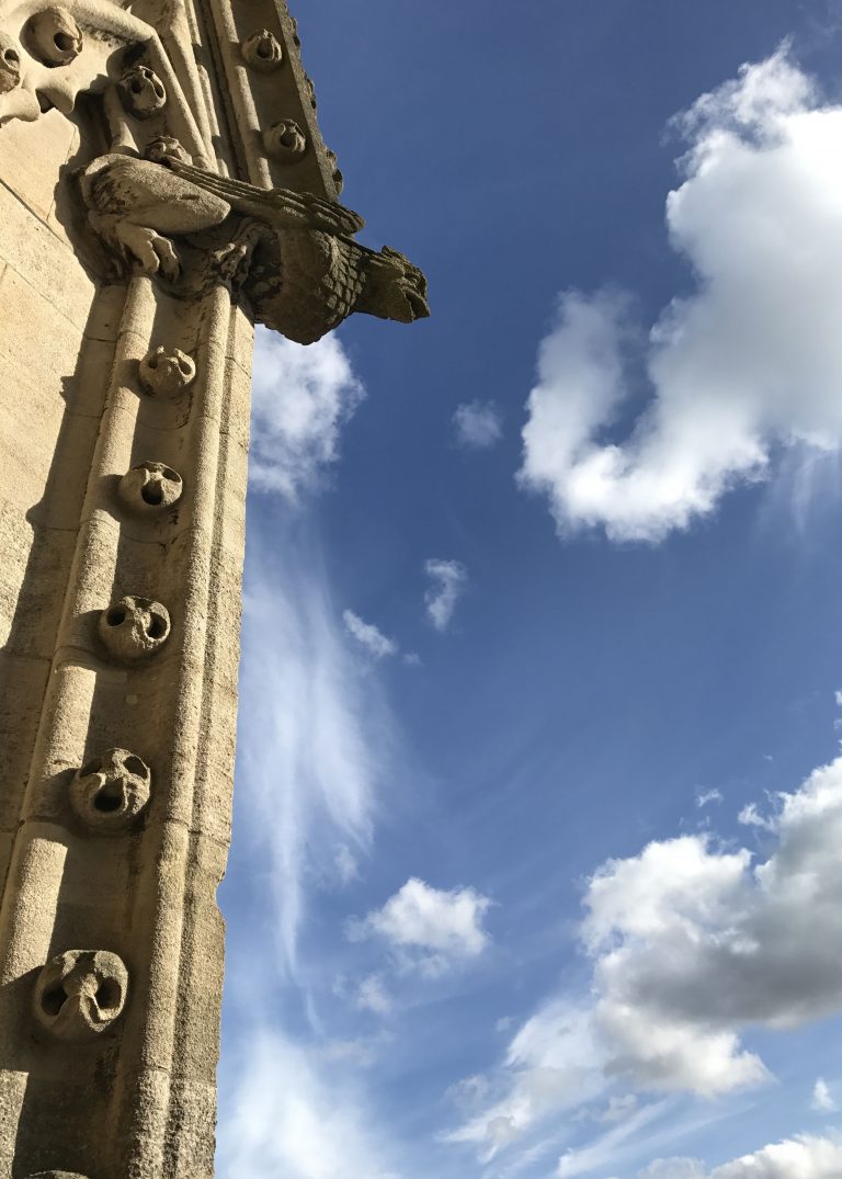 gargoyle against blue sky in Oxford, England