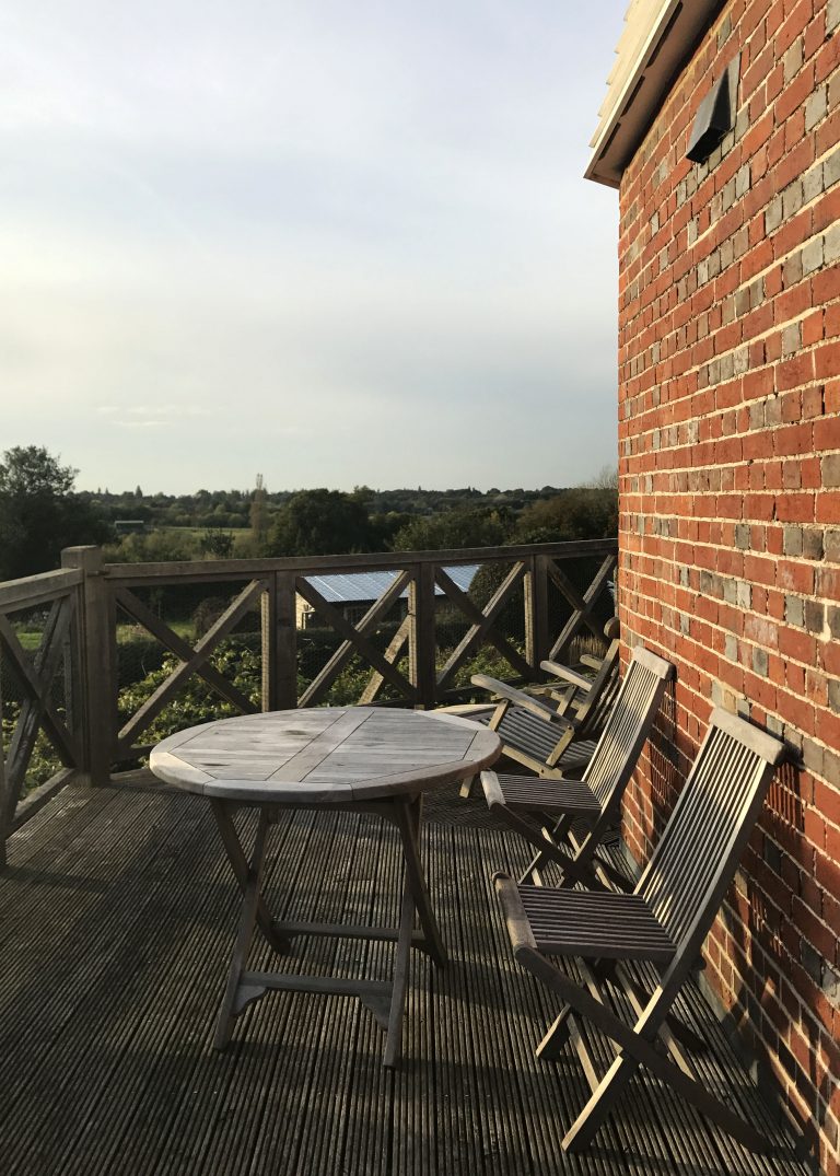 two wooden chairs on beacon hill mill deck in Benenden, England