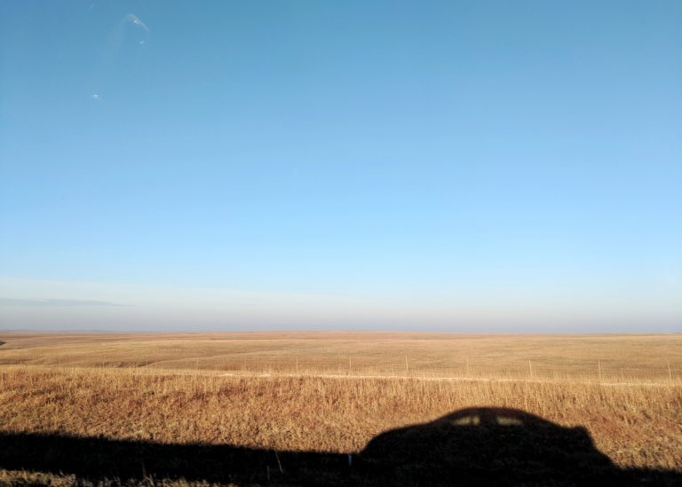 silhouette of car in flint hills in Kansas