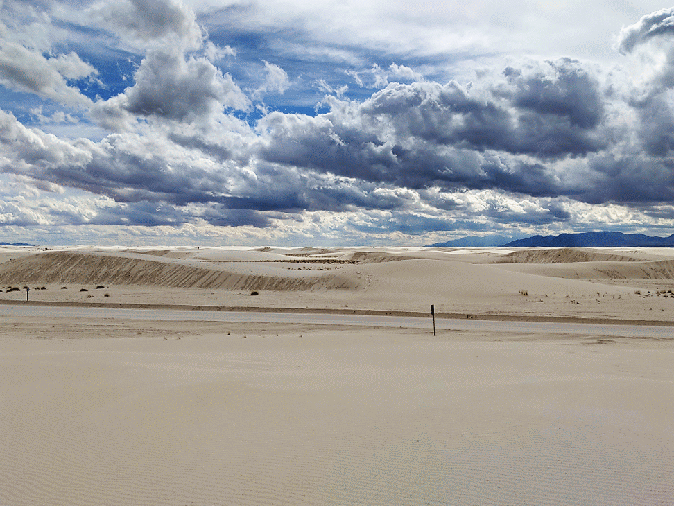 An RV drives through White Sands National Monument