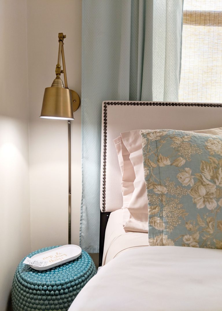 gold lamp and teal night stand