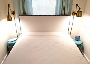 bed with fitted top sheet