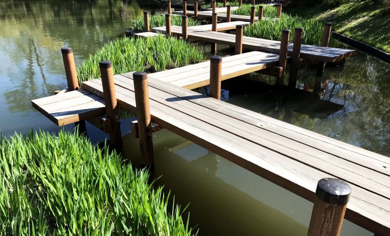 wooden planks over a pond