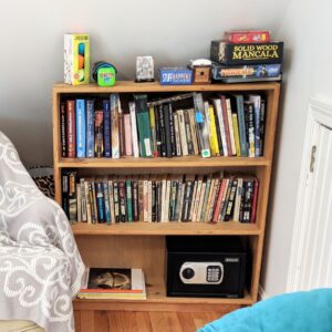 Airbnb shelf with games and books