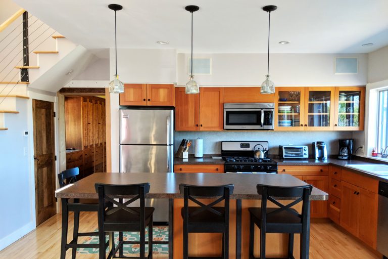 modern kitchen and stools at the Cherry Valley Farm Airbnb