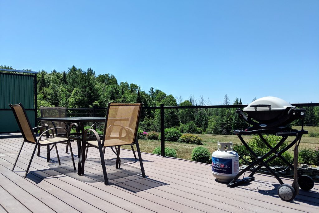 big porch with table and grill at Cherry Valley Farm Airbnb