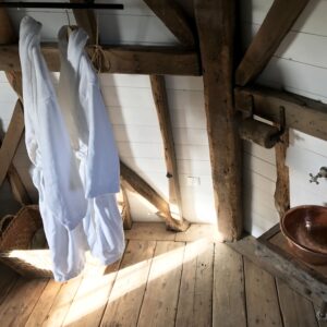 bathrobes hanging in rustic Airbnb bathroom